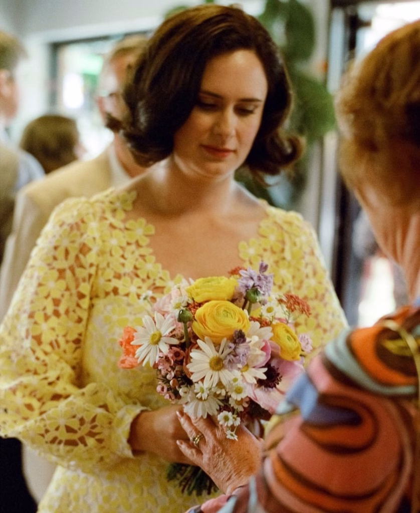 A soft-focus film photograph of a bride holding a lush, seasonal bouquet against the green lawns of the Adelaide Bowling Club, captured with nostalgic grain and natural light by Phoebe Kate Photography.